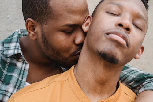 Free A Man Kissing His Partner's Neck Stock Photo