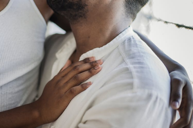 A Person's Hand On His Partner's Chest