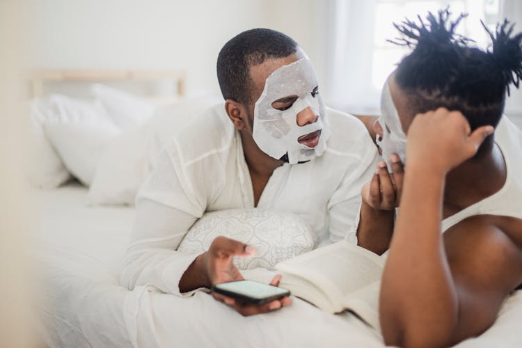 Two Men In Bedroom With Cosmetic Masks On Faces