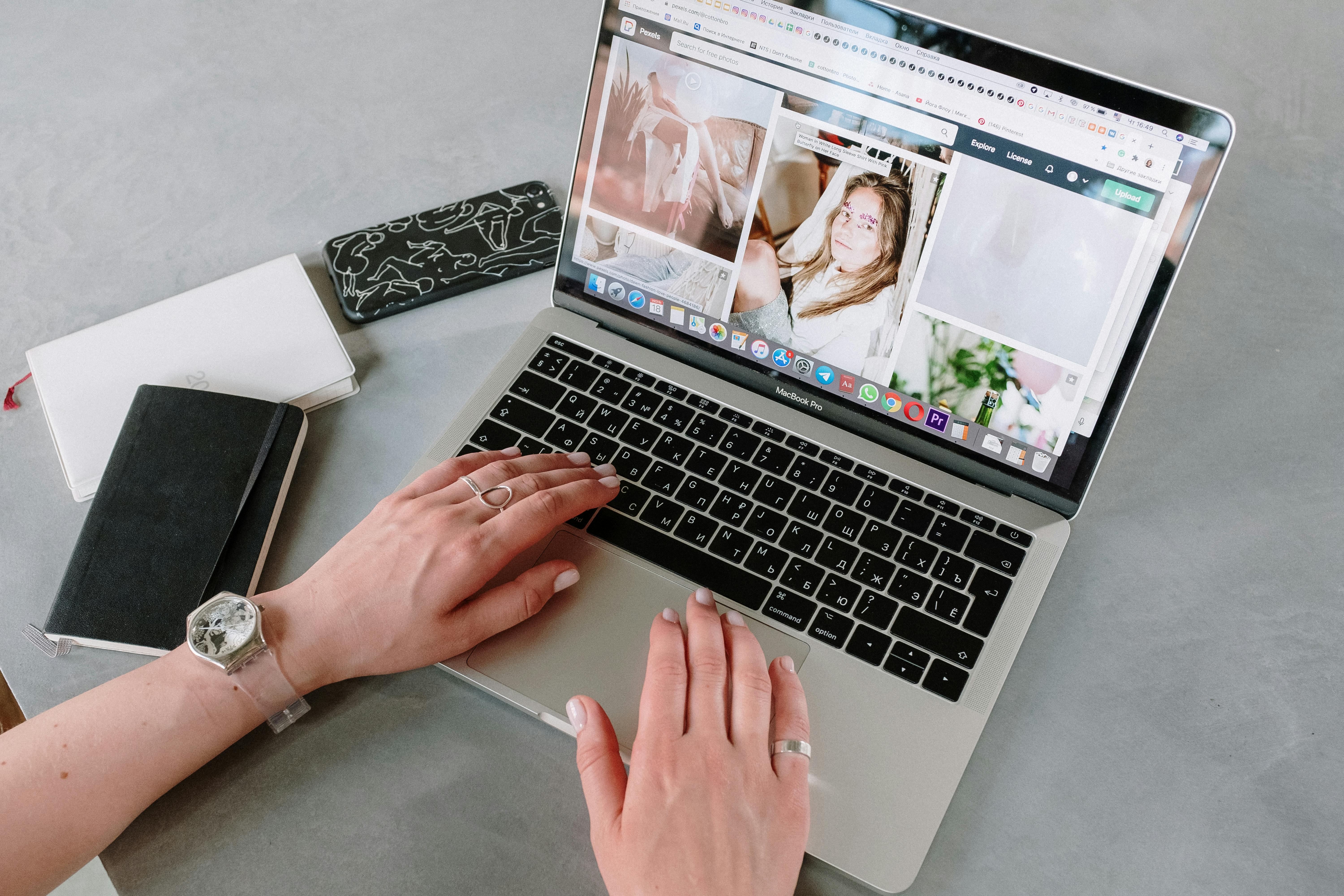 person using macbook pro on table