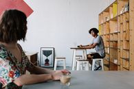 Woman in White Shirt Sitting on Chair