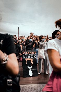 People Standing and Raising Hands