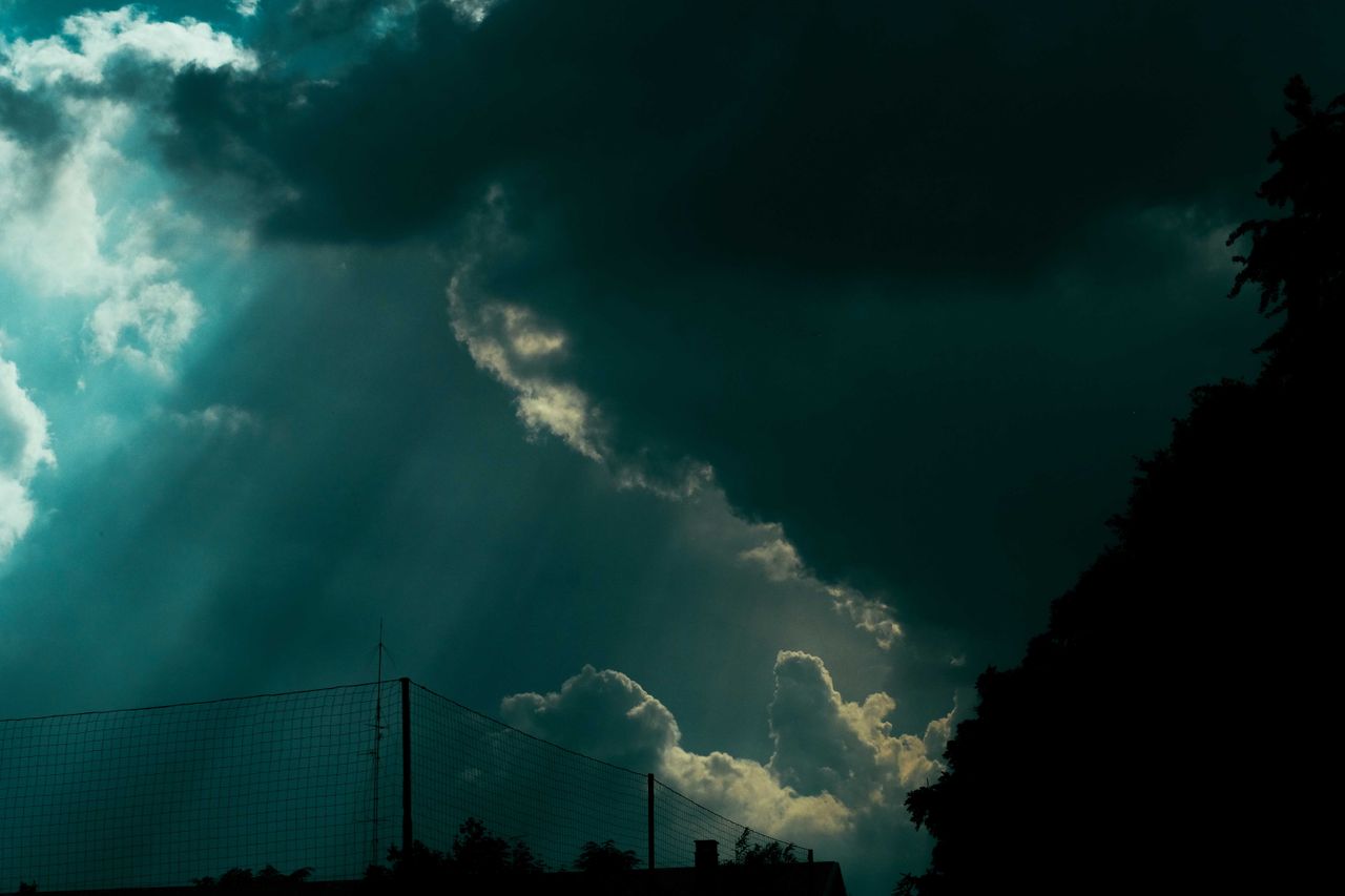 low angle dramatic overcast sky with heavy cumulus clouds floating ove
