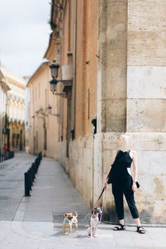 Woman in White Hijab and Black Dress Walking on Sidewalk
