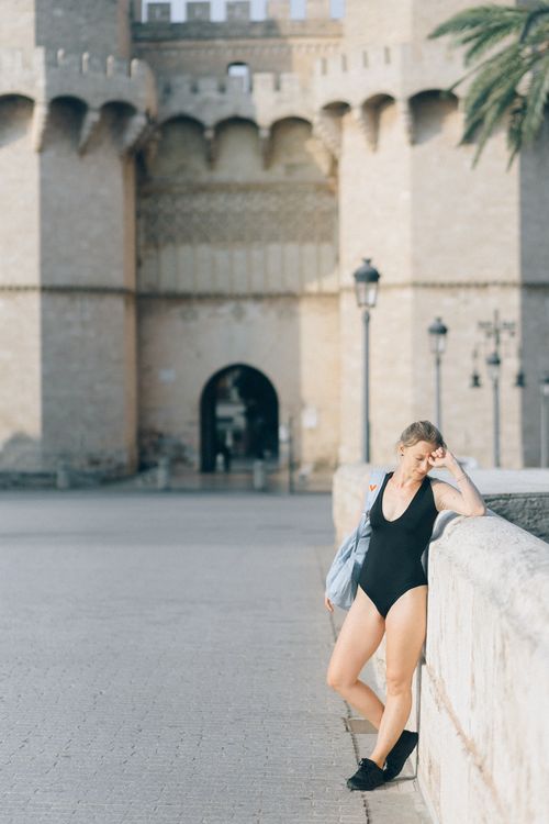 Photo of a Woman in a Black One Piece Walking · Free Stock Photo