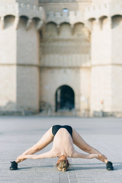 Free Photo of a Flexible Woman Touching Her Ankles Stock Photo