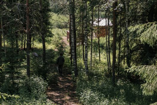 Man in Black Jacket Walking on Forest