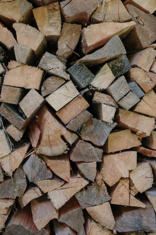 Free Close-up view of stacked chopped wood logs showcasing natural texture and rustic warmth. Stock Photo
