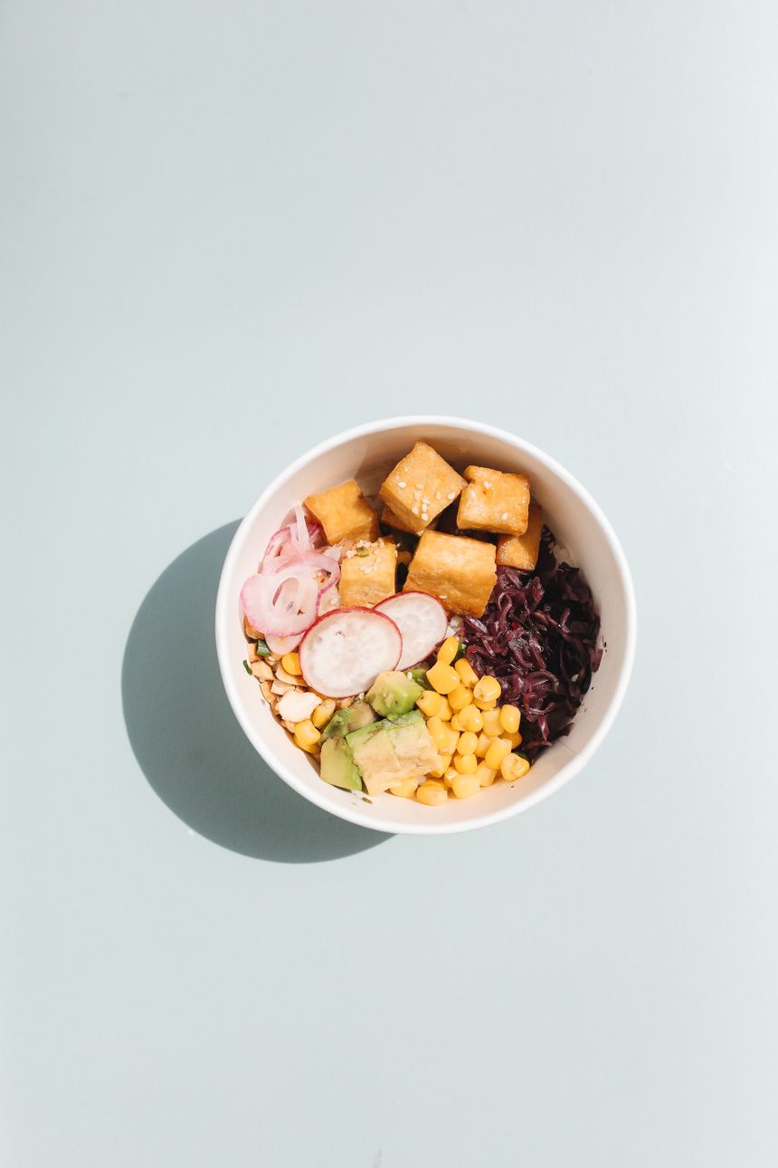 Overhead view of a grain bowl with tofu, avocado, corn and pickled radish — photo by Polina Tankilevitch on Pexels