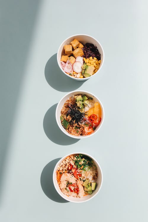 Photograph of Poke Bowls on a Blue Surface · Free Stock Photo