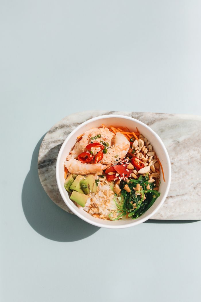 Salmon poke bowl with avocado and chili