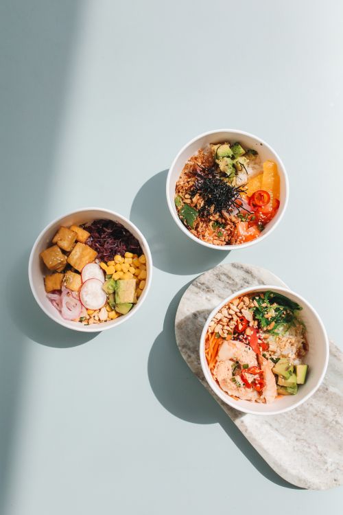 Free Three colorful Hawaiian poke bowls with fresh ingredients in bright lighting. Stock Photo