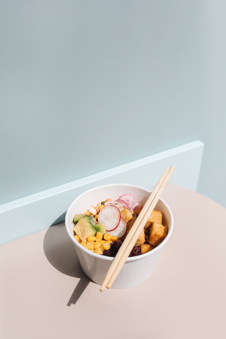 Photo Of Chopsticks On Top Of A Poke Bowl With Corn And Tofu