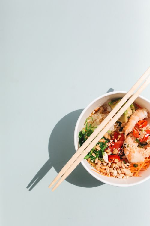 Free Bright overhead shot of a delicious Hawaiian poke bowl with shrimp, avocado, and vegetables. Stock Photo