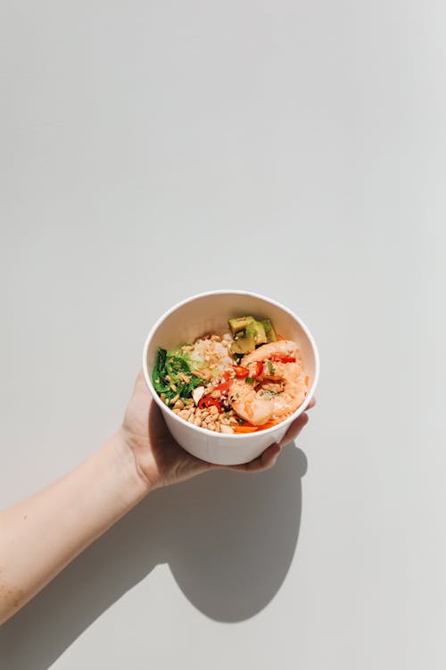 Hand Holding a Poke Bowl 