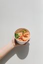 Hand Holding a Poke Bowl