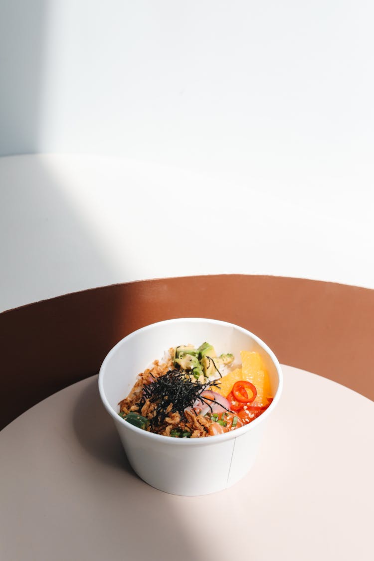 Poke Bowl With Avocado Slices And Nuts 