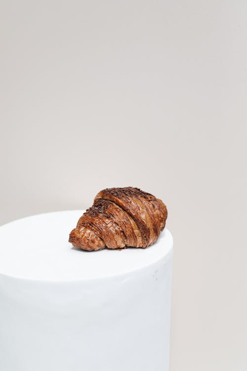 Free Photo of a Chocolate Croissant on a Cylinder Stock Photo