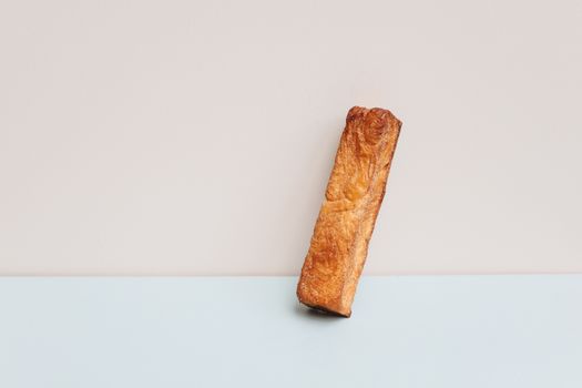 A single piece of crusty bread against a minimalist background, perfect for food lovers.