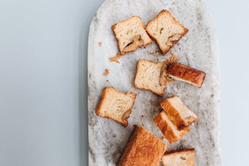 Free Pieces Brown Bread on a Marble Tray Stock Photo