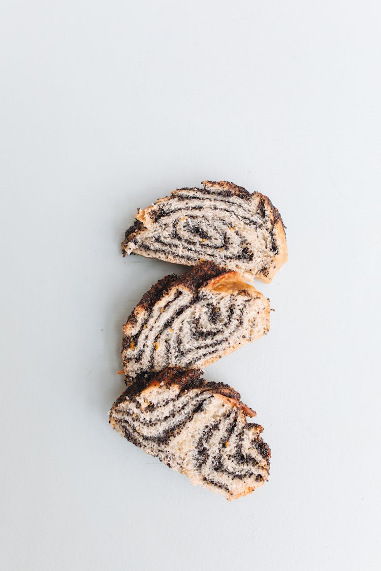 A Few Slices Of Cinnamon Swirl Bread On White Surface