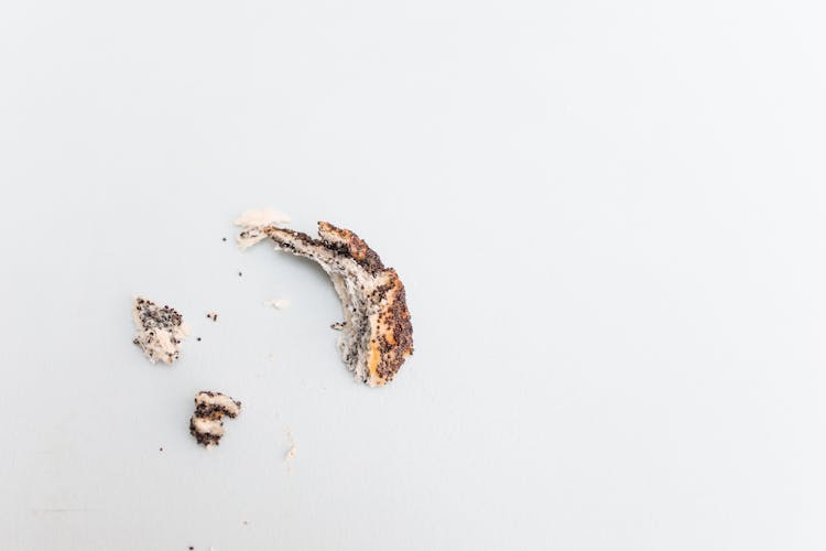 A Few Pieces Of Leftover Bread On White Surface