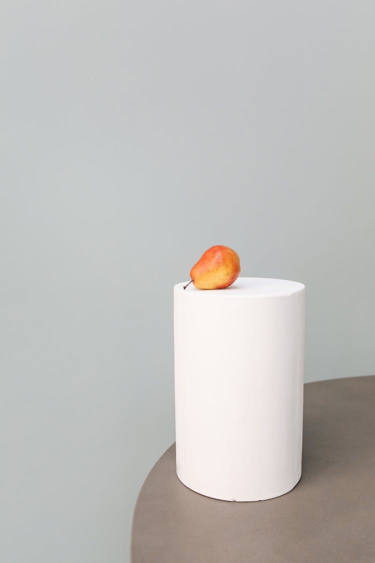 A Piece Of Pear Fruit On A White Round Stool