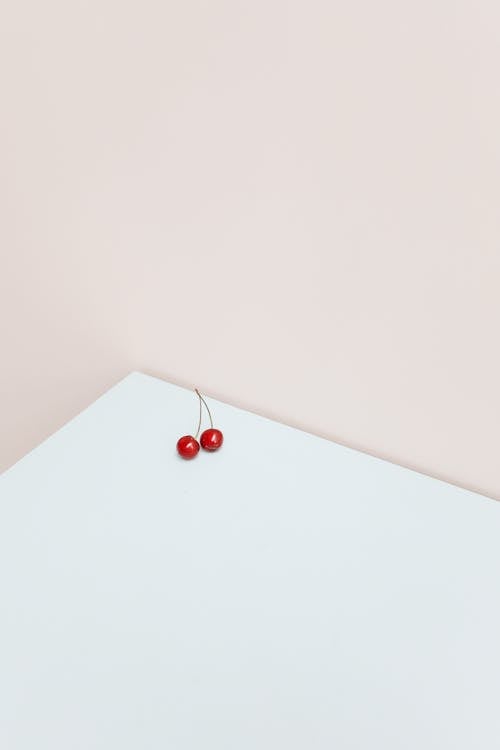 Photo of Red Cherries on the Edge of a Table