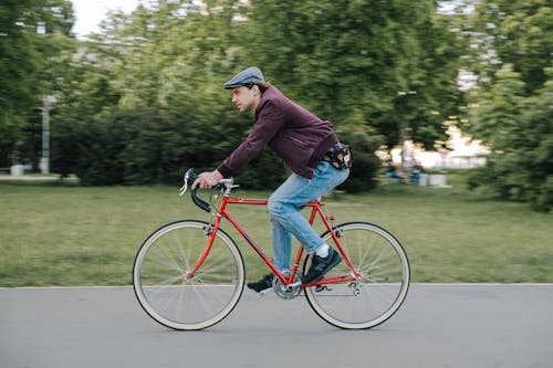 Side View of a Man with a Beret Cap Riding a Bicycle