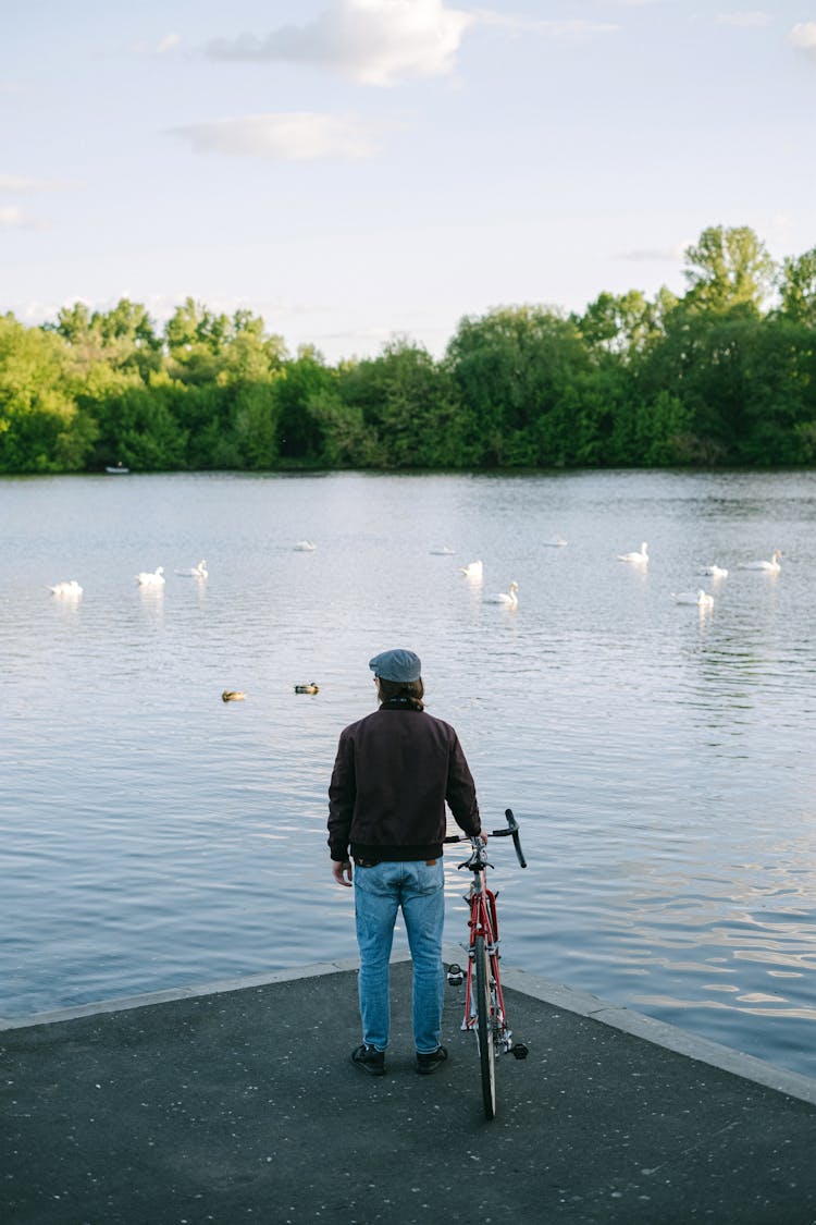 Back View Of Person Standing Near The Lake