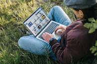 Person Looking at Images on a Laptop