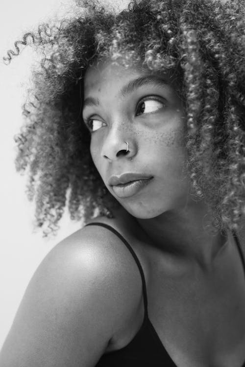 Grayscale Photo of a Woman with Curly Hair