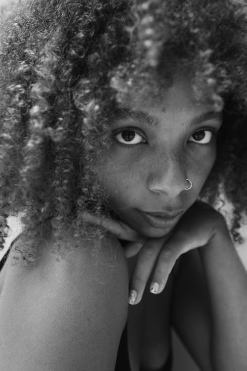 Grayscale Photo of a Woman With Curly Hair