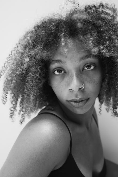 Grayscale Photo of a Woman with a Nose Piercing