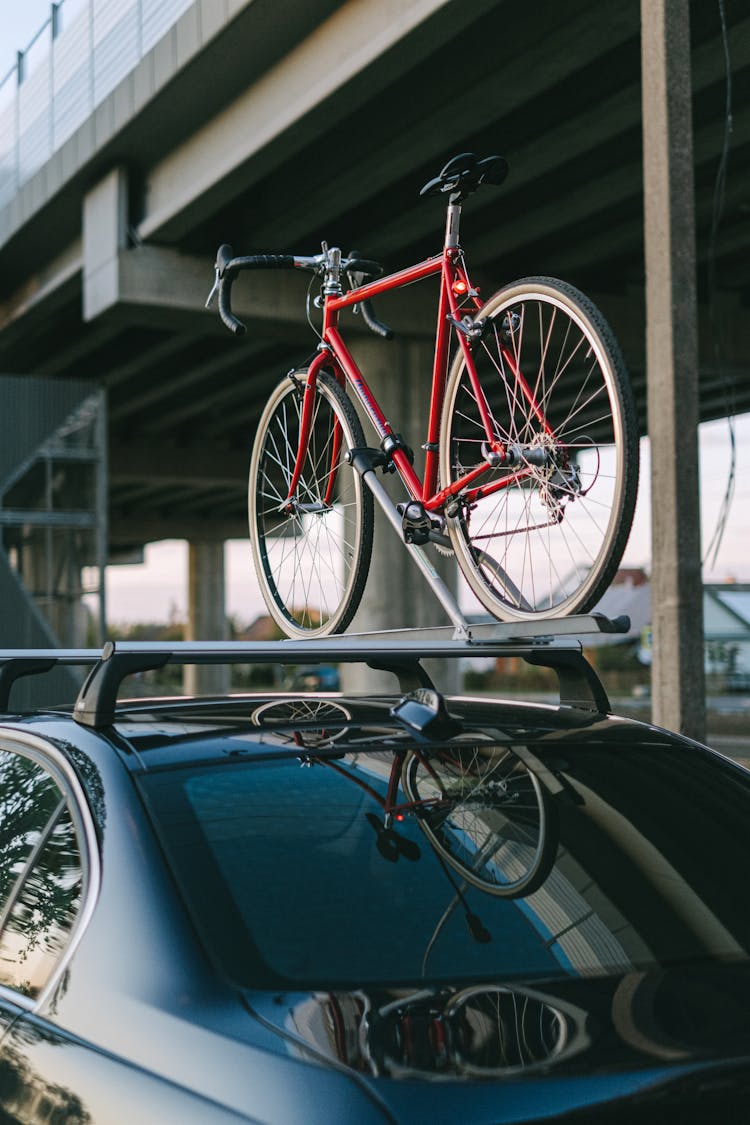 A Bike On The Roof Rack Of A Car