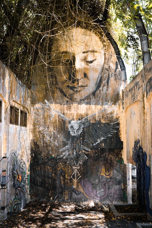 Vertical Shot of a Mural inside an Abandoned Building