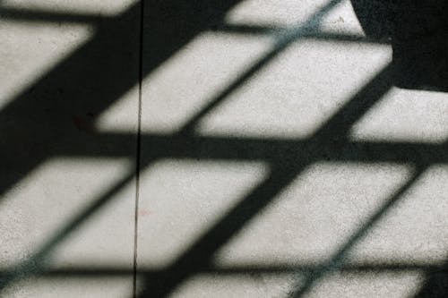 Shadow of Person on White Tiles