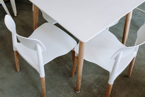 White Plastic Chair Beside Table