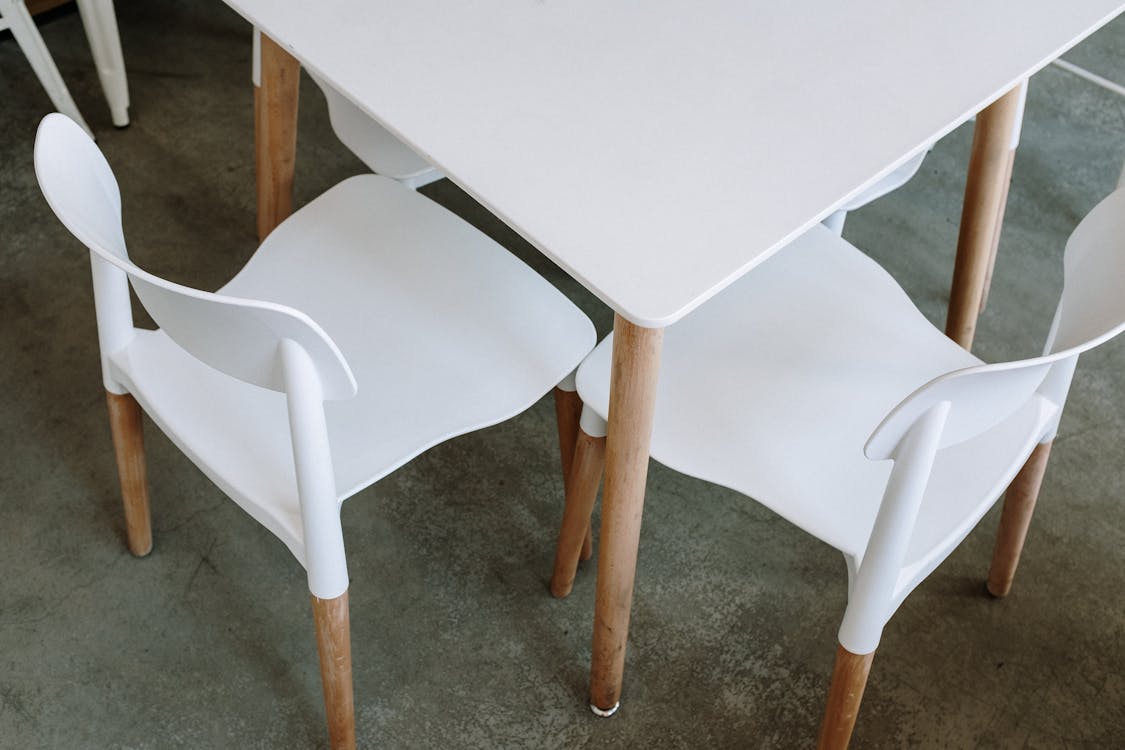 White Plastic Chair Beside Table · Free Stock Photo