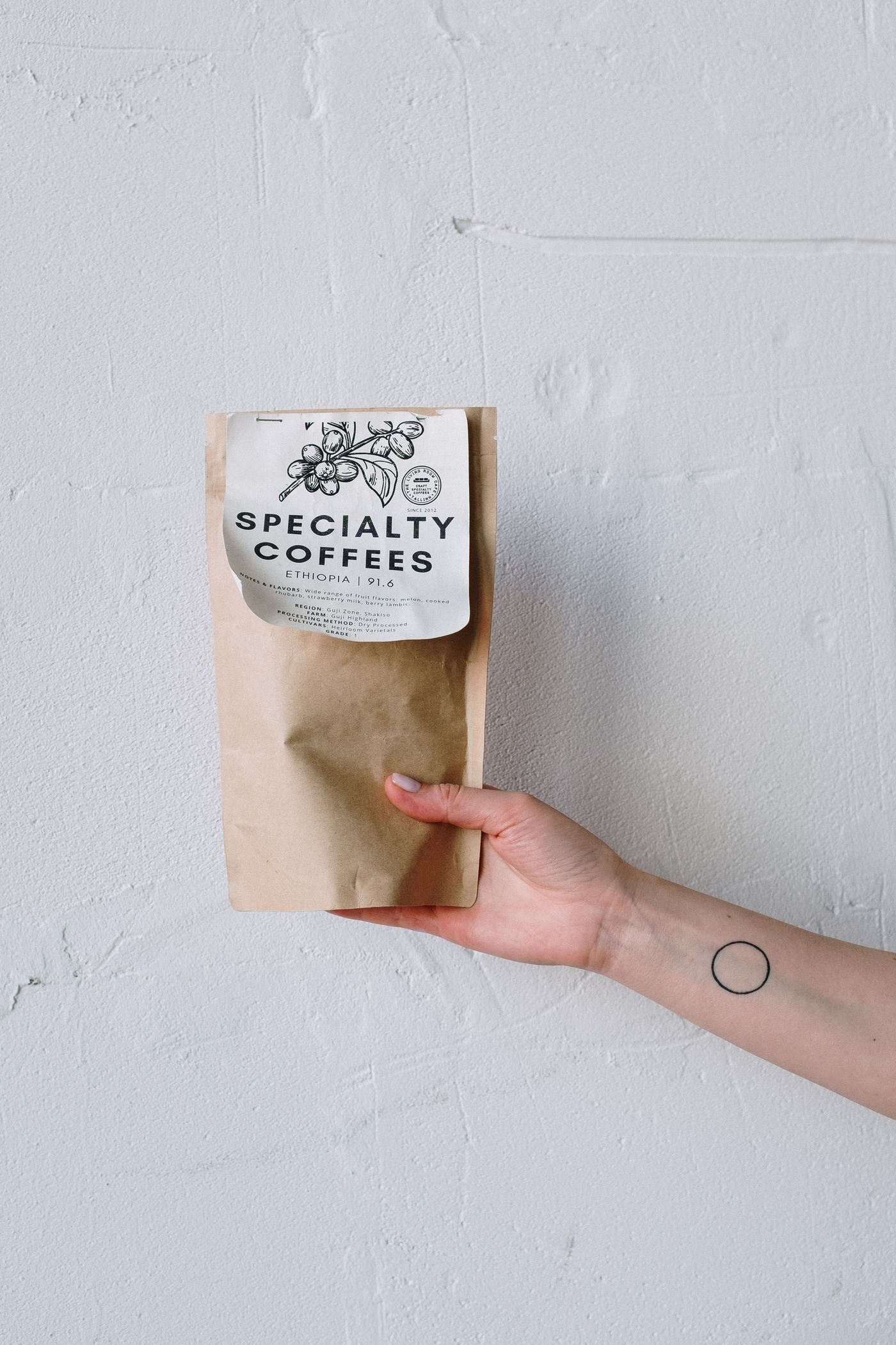 Hand holding a kraft coffee bag