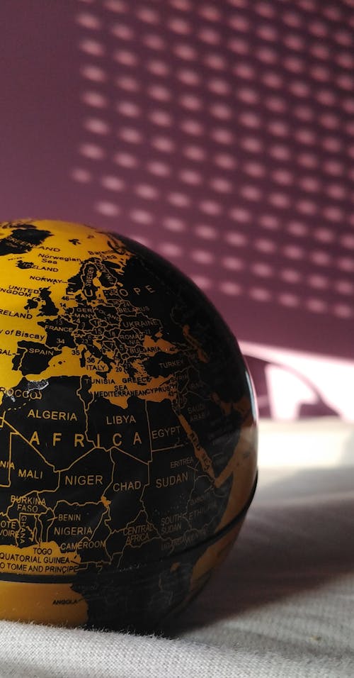 Close Up Photo of Black and Yellow Globe 