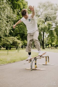 Man Sliding on Metal Railing using Skateboard