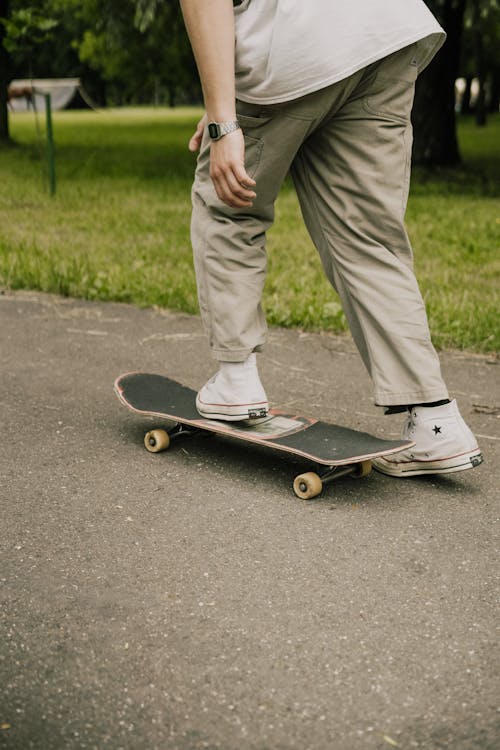 A Person Doing a Kick Push while Riding a Skateboard