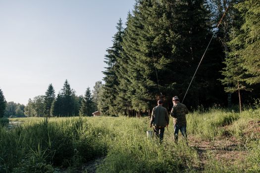 2 Men Walking on Green Grass Field