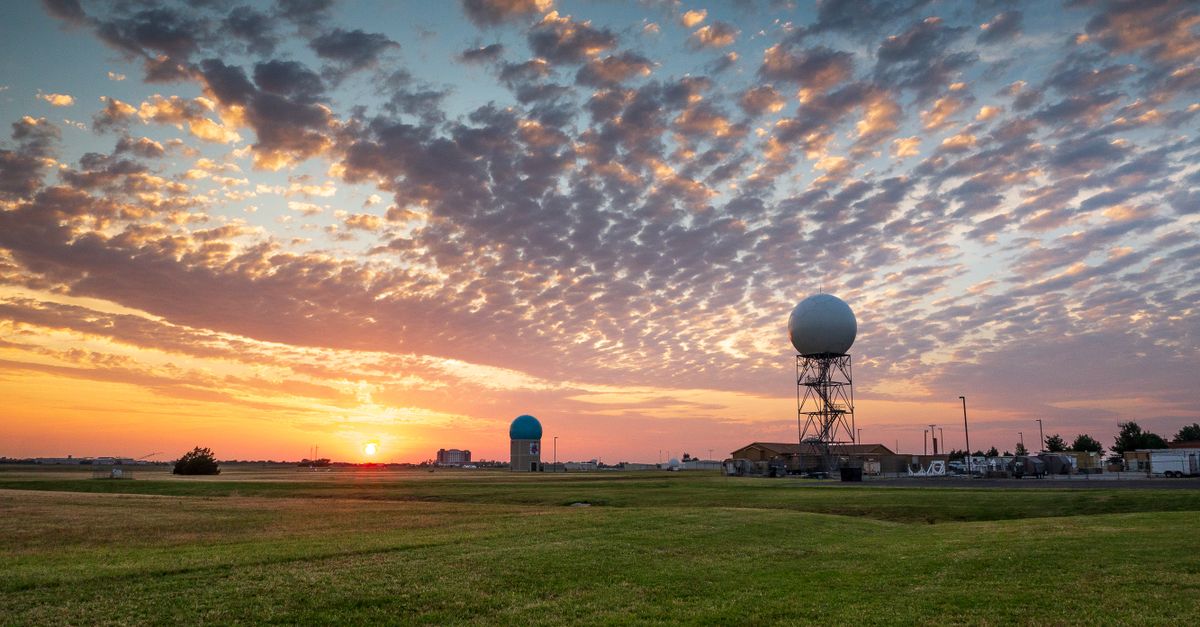 Sunset over a weather station in Norman, Oklahoma, with dramatic sky and clouds.