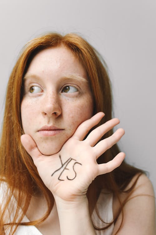 
A Woman with a Written Word on Her Hand