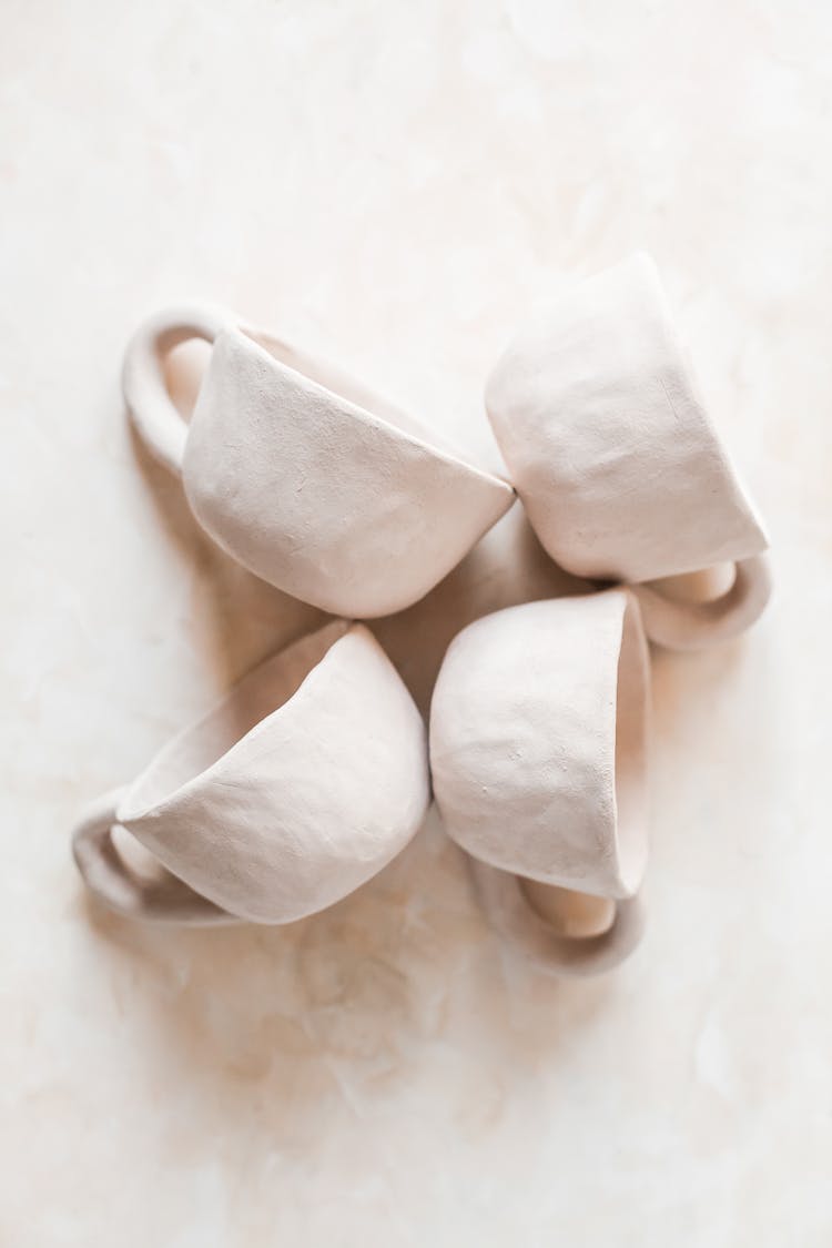 White Ceramic Cups Placed On Table