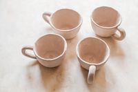 Angled view of the four-mug set — photo by Diana Light on Pexels