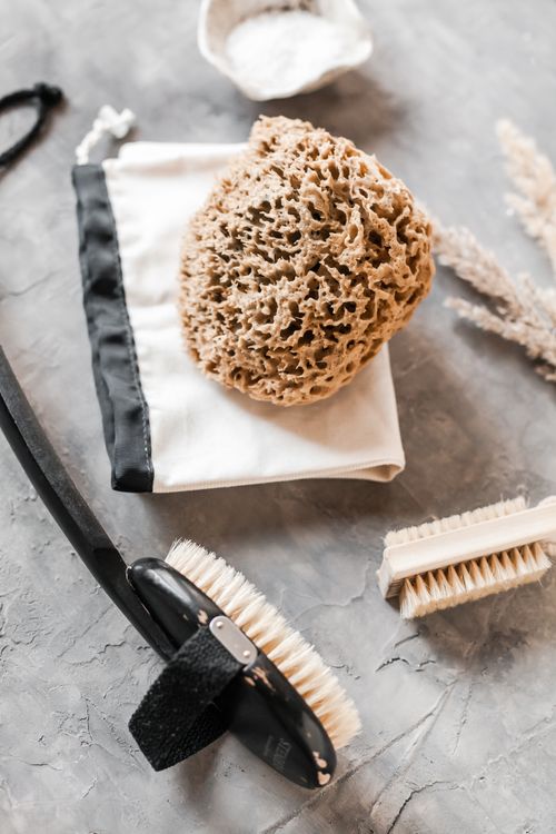 Free High angle of eco friendly pumice placed on eco pouch near wooden brushes for body Stock Photo