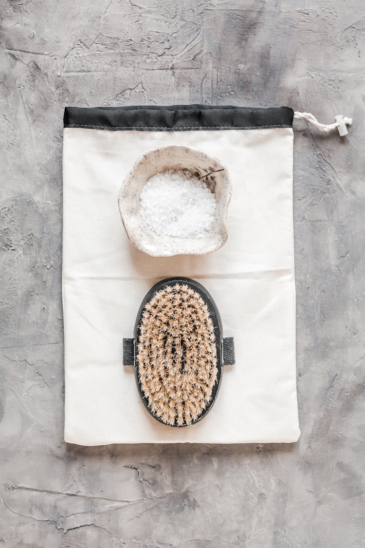 Body Brush And Bath Salt On Gray Marble Table